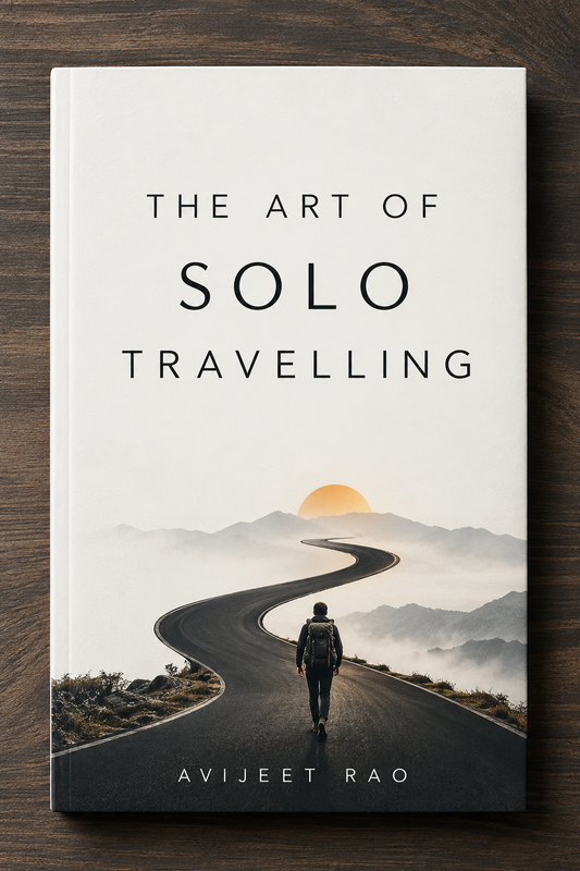 Cover of The Art of Solo Travelling by Avijeet Rao: a backpacker walking along a winding mountain road towards a rising sun